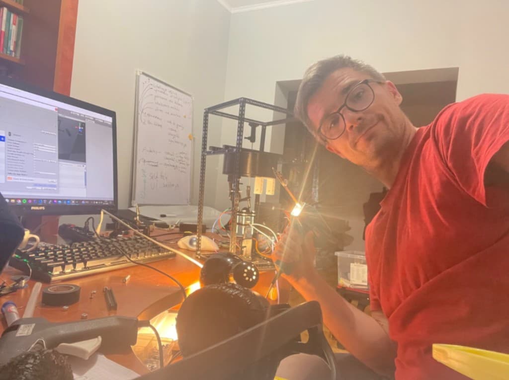 Piotr Dul przy stanowisku z Unity, tablicą i prototypem sprzętowym — praca nad VR i rozwojem produktu